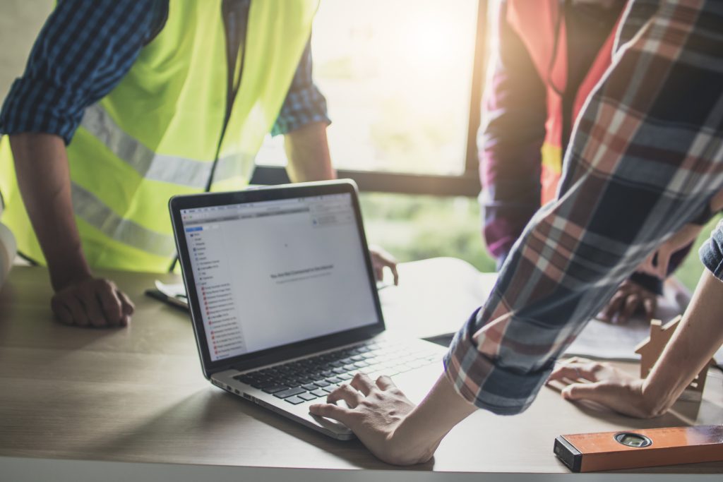 Engineer and worker planning for construction building and renovate in working site